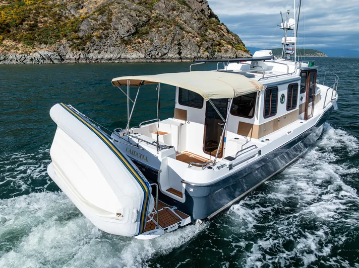 Caldonia Yacht Photos Pics 2013 Ranger Tugs R 29 cruising near rocky coastline.