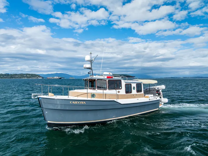Caldonia Yacht Photos Pics 2013 Ranger Tugs R 29 boat cruising on open water under a partly cloudy sky.