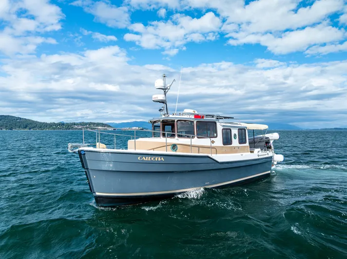 Caldonia Yacht Photos Pics 2013 Ranger Tugs R 29 boat cruising on open water under a partly cloudy sky.