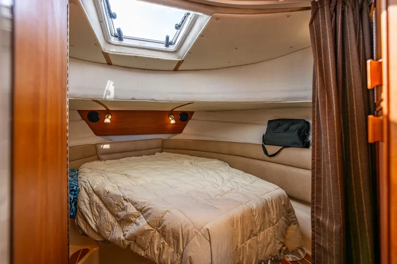 Caldonia Yacht Photos Pics Cozy cabin interior of 2013 Ranger Tugs R 29 with bed and skylight.