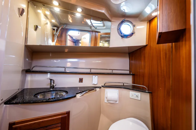 Caldonia Yacht Photos Pics Luxurious bathroom in 2013 Ranger Tugs R 29 boat with modern fixtures and wood accents.