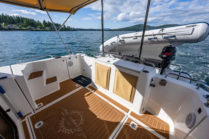 Caldonia Yacht Photos Pics 2013 Ranger Tugs R 29 boat deck with wood flooring, scenic water view, and inflatable dinghy.