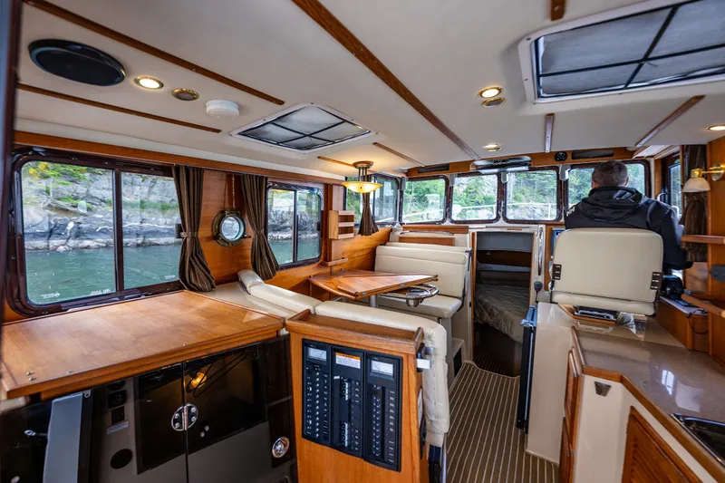 Caldonia Yacht Photos Pics Interior of 2013 Ranger Tugs R 29 boat with wood finishes and seating area.