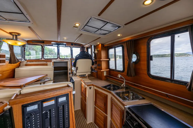 Caldonia Yacht Photos Pics Interior of 2013 Ranger Tugs R 29 boat with wood finish and modern amenities.