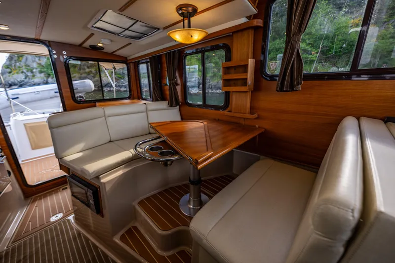 Caldonia Yacht Photos Pics Interior of 2013 Ranger Tugs R 29 boat with elegant seating and wooden accents.