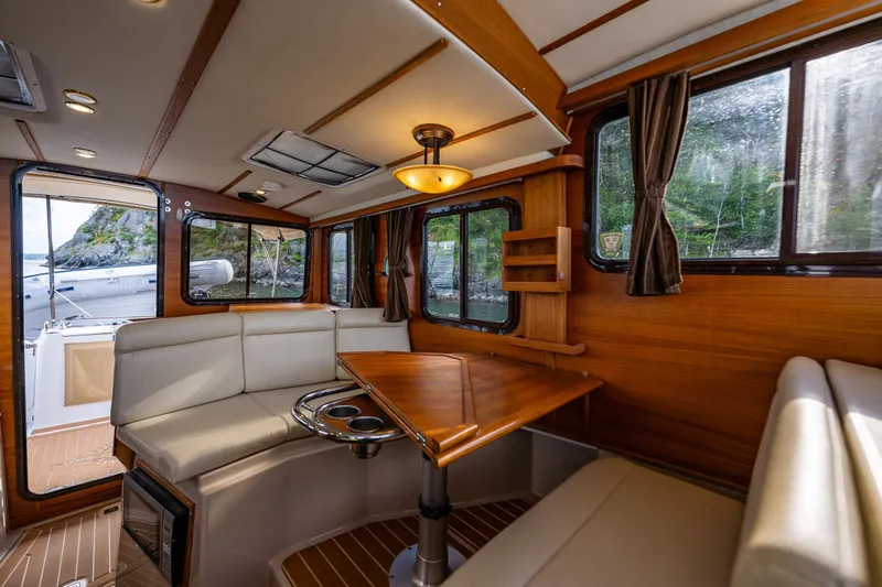 Caldonia Yacht Photos Pics Interior of 2013 Ranger Tugs R 29 boat with wood finish and seating area.
