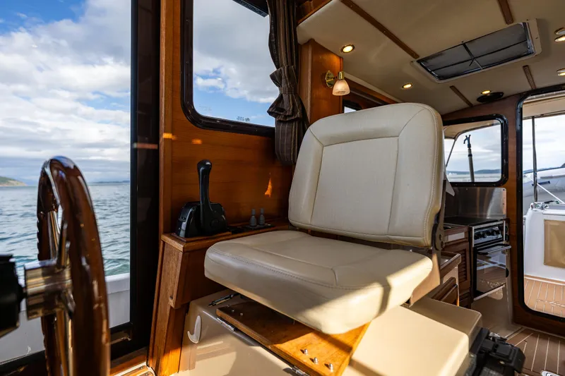 Caldonia Yacht Photos Pics Interior of 2013 Ranger Tugs R 29 boat with helm seat and ocean view.