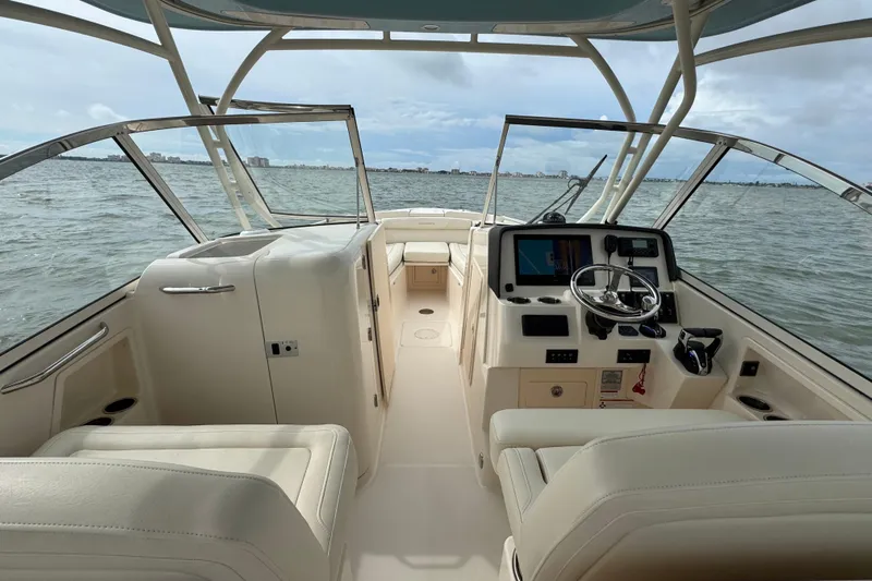 That's What She Said Yacht Photos Pics 2023 Grady-White Freedom 285 boat interior with steering console and seating on open water.