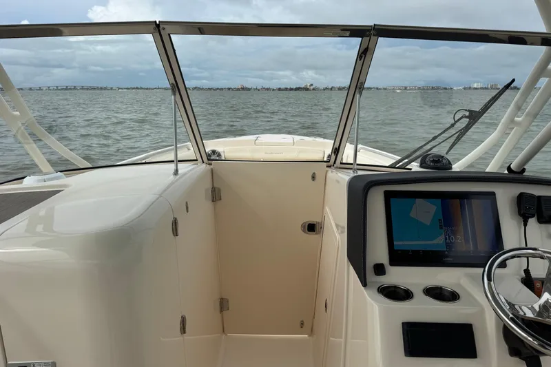 That's What She Said Yacht Photos Pics 2023 Grady-White Freedom 285 boat interior with navigation system, on calm waters.