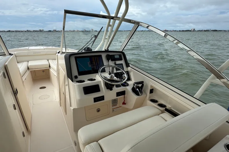 That's What She Said Yacht Photos Pics 2023 Grady-White Freedom 285 boat interior with steering console, on a calm sea.