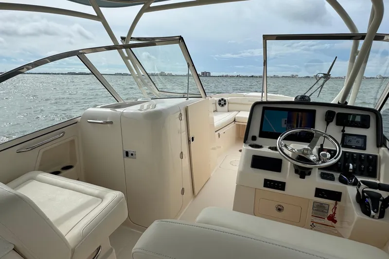 That's What She Said Yacht Photos Pics 2023 Grady-White Freedom 285 boat interior with steering console and seating, on open water.