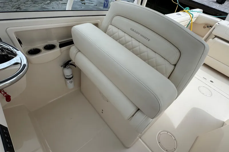 That's What She Said Yacht Photos Pics 2023 Grady-White Freedom 285 boat interior with steering wheel and cushioned seating.
