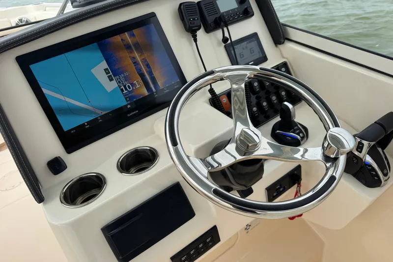 That's What She Said Yacht Photos Pics 2023 Grady-White Freedom 285 boat dashboard with steering wheel and navigation display.