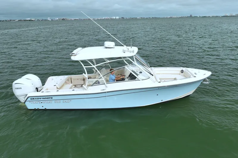 That's What She Said Yacht Photos Pics 2023 Grady-White Freedom 285 boat on calm water, side view.