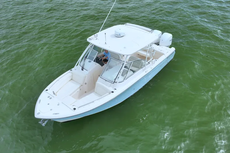 That's What She Said Yacht Photos Pics 2023 Grady-White Freedom 285 boat on calm green water.