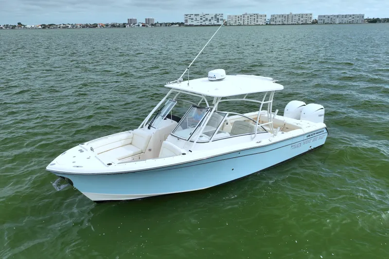 That's What She Said Yacht Photos Pics 2023 Grady-White Freedom 285 boat on calm water, cityscape in background.