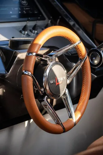  Yacht Photos Pics Steering wheel of 2024 Wider Wilder 60 yacht, featuring sleek design and leather grip.