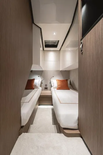  Yacht Photos Pics 2024 Wider Wilder 60 yacht cabin with twin beds, modern design, and warm lighting.