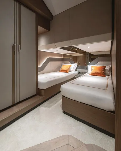  Yacht Photos Pics Luxurious 2024 Wider Wilder 60 yacht cabin with twin beds and modern decor.