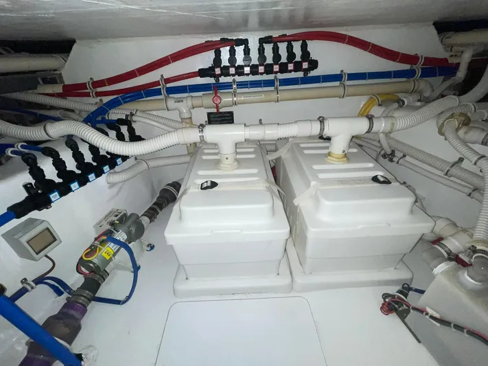 Caraibi Yacht Photos Pics Engine room of 2013 Hatteras GT63 yacht with complex piping and equipment.