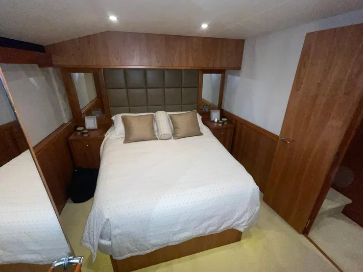 Caraibi Yacht Photos Pics Luxurious bedroom interior of 2013 Hatteras GT63 yacht with elegant wood finishes.
