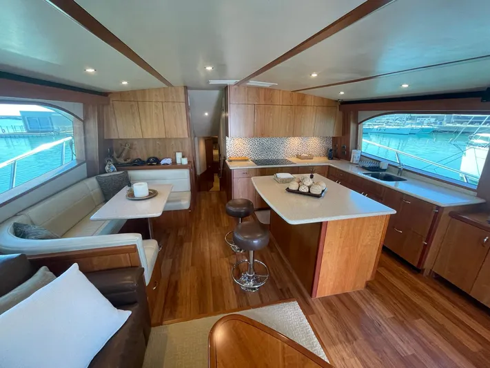 Caraibi Yacht Photos Pics Luxurious interior of 2013 Hatteras GT63 yacht with modern kitchen and seating area.