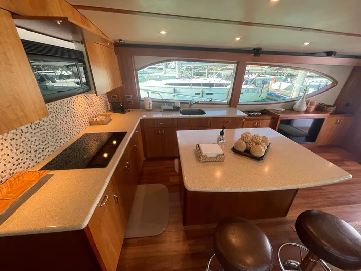 Caraibi Yacht Photos Pics Luxurious 2013 Hatteras GT63 yacht kitchen with modern amenities and elegant design.