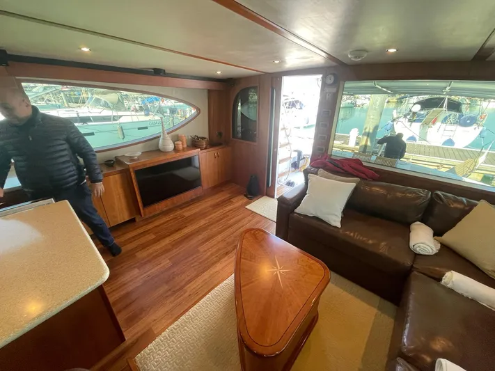 Caraibi Yacht Photos Pics Luxurious interior of 2013 Hatteras GT63 yacht with leather seating and wooden finishes.