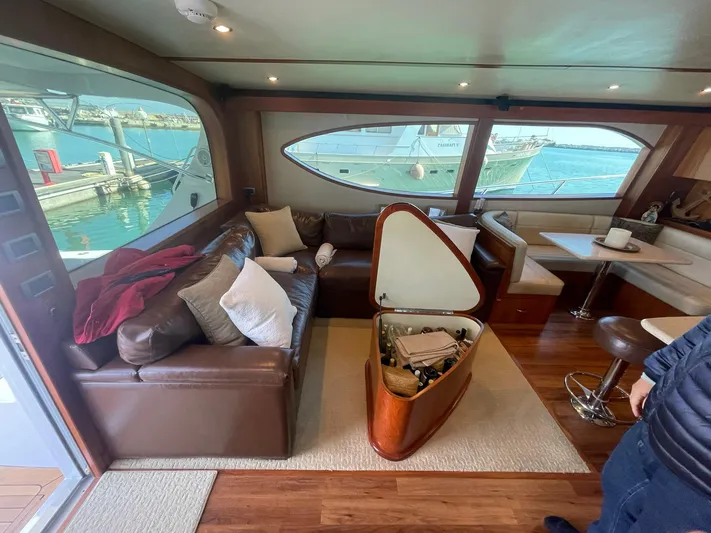 Caraibi Yacht Photos Pics Luxurious interior of 2013 Hatteras GT63 yacht with leather seating and marina view.