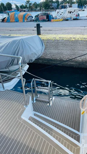  Yacht Photos Pics Leopard 53 yacht docked at marina, 2023 model, with covered equipment and water access ladder.