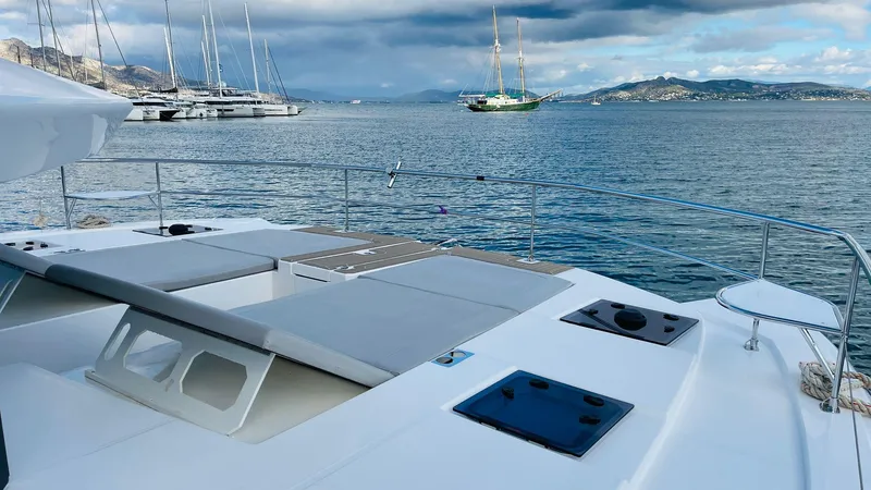  Yacht Photos Pics Luxurious 2023 Leopard 53 yacht on serene waters with scenic mountain backdrop.