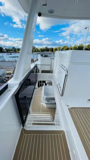  Yacht Photos Pics 2023 Leopard 53 yacht deck with sleek design and modern features under a blue sky.