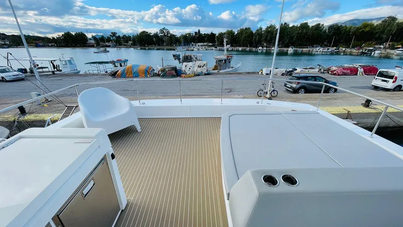  Yacht Photos Pics Leopard 53 yacht deck overlooking marina, featuring seating and storage, 2023 model.