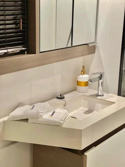  Yacht Photos Pics Modern bathroom sink in Leopard 53 yacht, 2023 model, with sleek faucet and toiletries.