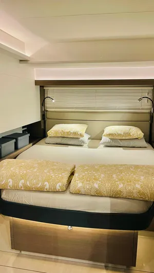  Yacht Photos Pics Luxurious bedroom interior of 2023 Leopard 53 yacht with elegant bedding and modern lighting.