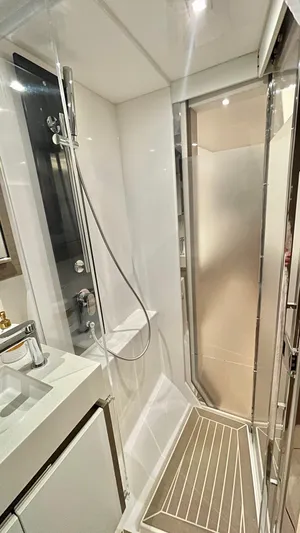  Yacht Photos Pics Modern bathroom in 2023 Leopard 53 yacht with sleek shower and elegant fixtures.