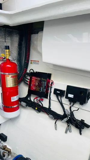  Yacht Photos Pics Engine room of 2023 Leopard 53 yacht with fire extinguisher and electrical components.