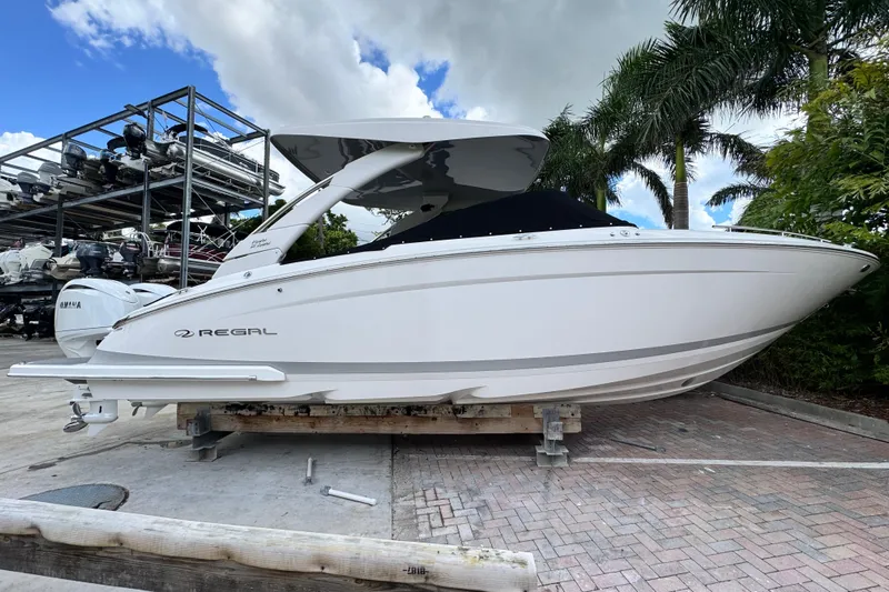 Yacht Photos Pics 2024 Regal LX9 boat on display, sleek design, parked outdoors with palm trees.