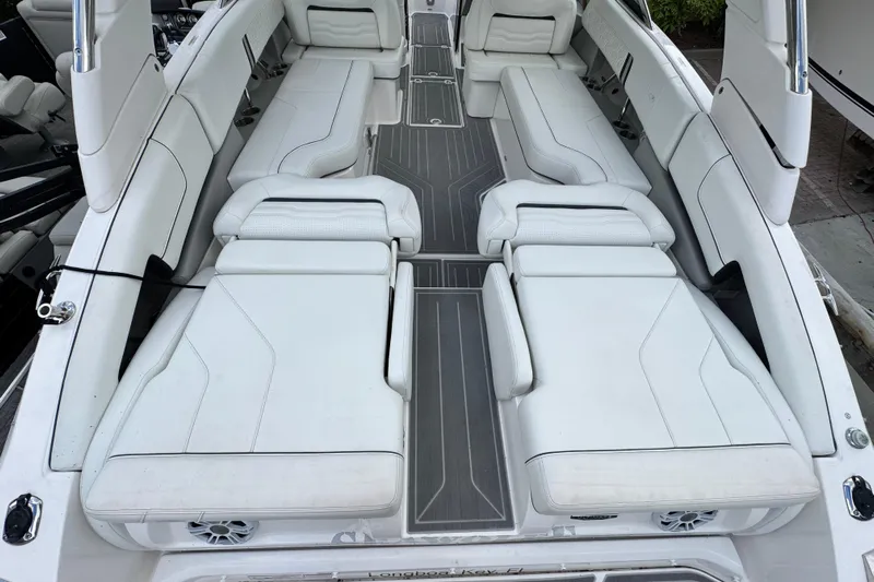  Yacht Photos Pics 2024 Regal LX9 boat interior with white cushioned seating and sleek design.