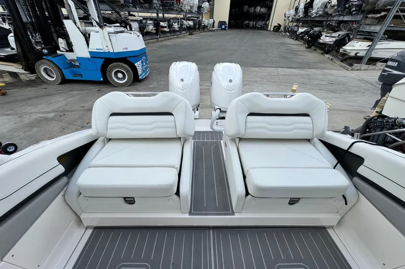  Yacht Photos Pics 2024 Regal LX9 boat interior with white seating and dual engines in a marina setting.