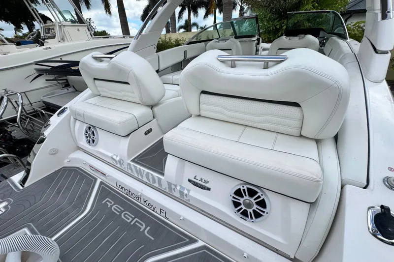  Yacht Photos Pics 2024 Regal LX9 boat interior with white seating and speaker system.