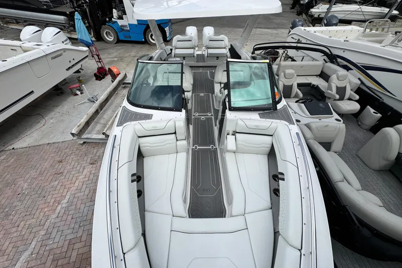  Yacht Photos Pics 2024 Regal LX9 boat with luxurious seating and sleek design at a marina.