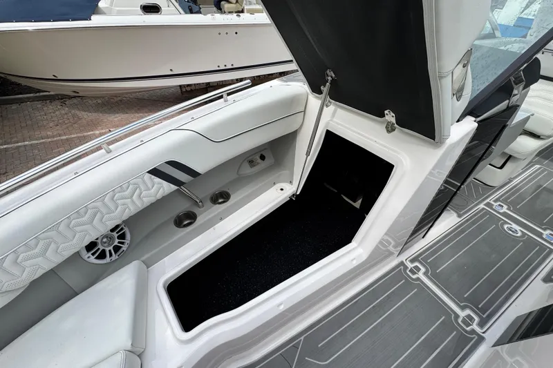  Yacht Photos Pics 2024 Regal LX9 boat interior with open storage compartment and stylish seating.