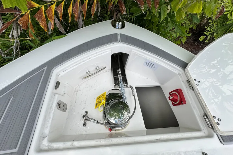  Yacht Photos Pics 2024 Regal LX9 boat anchor compartment with lush greenery background.