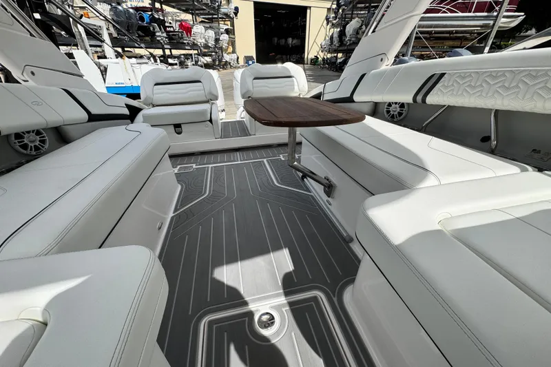  Yacht Photos Pics 2024 Regal LX9 boat interior with white seating and wooden table.