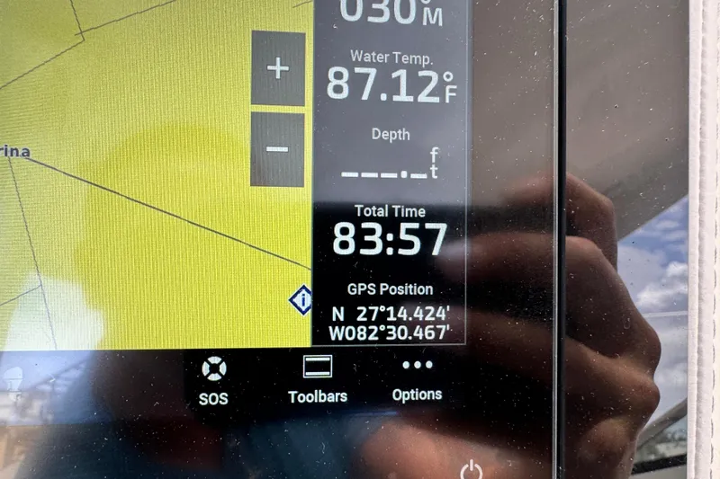  Yacht Photos Pics Boat navigation display showing GPS coordinates, water temperature, and total time on a Regal LX9, 2024.