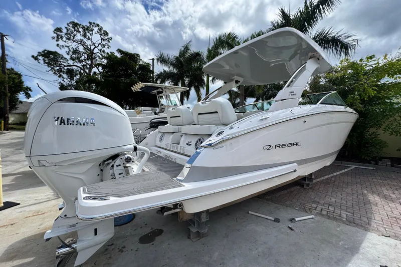  Yacht Photos Pics 2024 Regal LX9 boat with Yamaha engine, parked outdoors under cloudy sky.