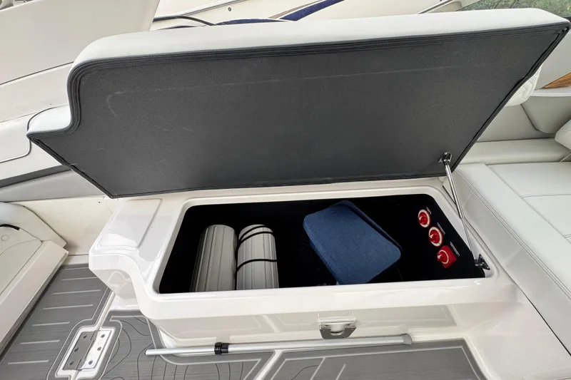  Yacht Photos Pics 2024 Regal LX9 boat storage compartment with accessories and safety equipment.