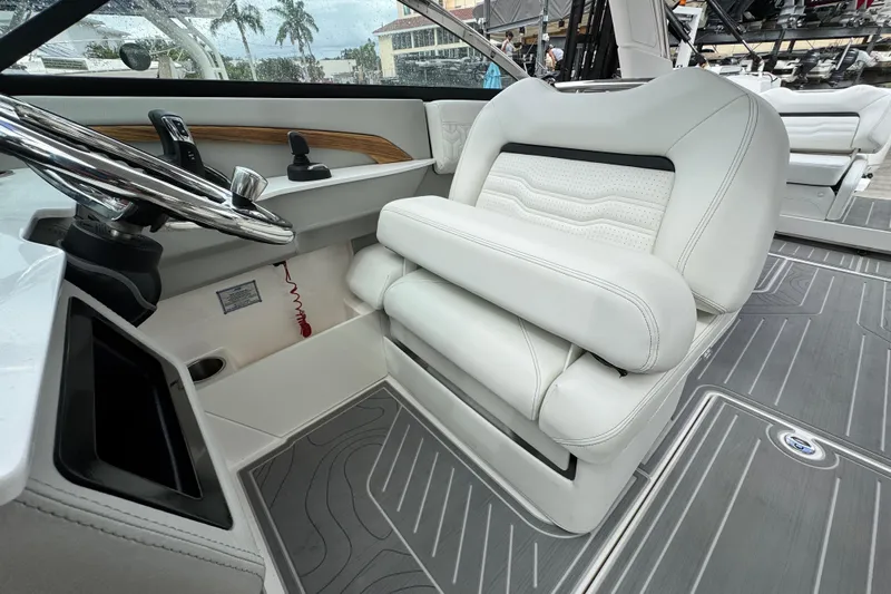  Yacht Photos Pics 2024 Regal LX9 boat interior with white leather seating and modern steering wheel.