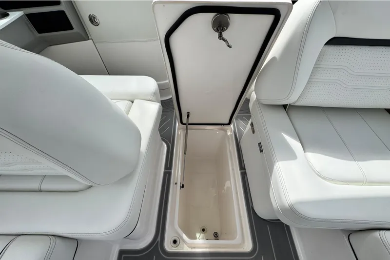  Yacht Photos Pics 2024 Regal LX9 boat interior with open storage compartment and white seating.